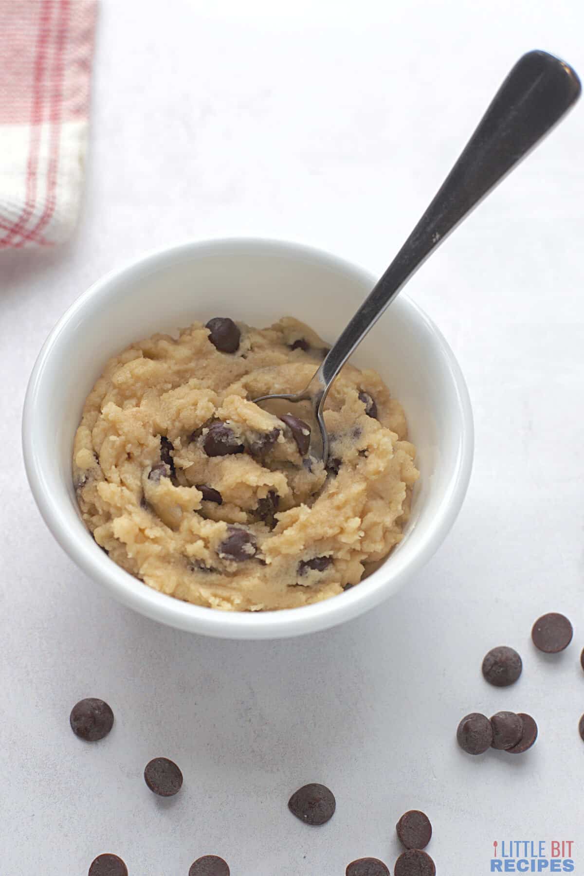 cookie dough in small white bowl with spoon.