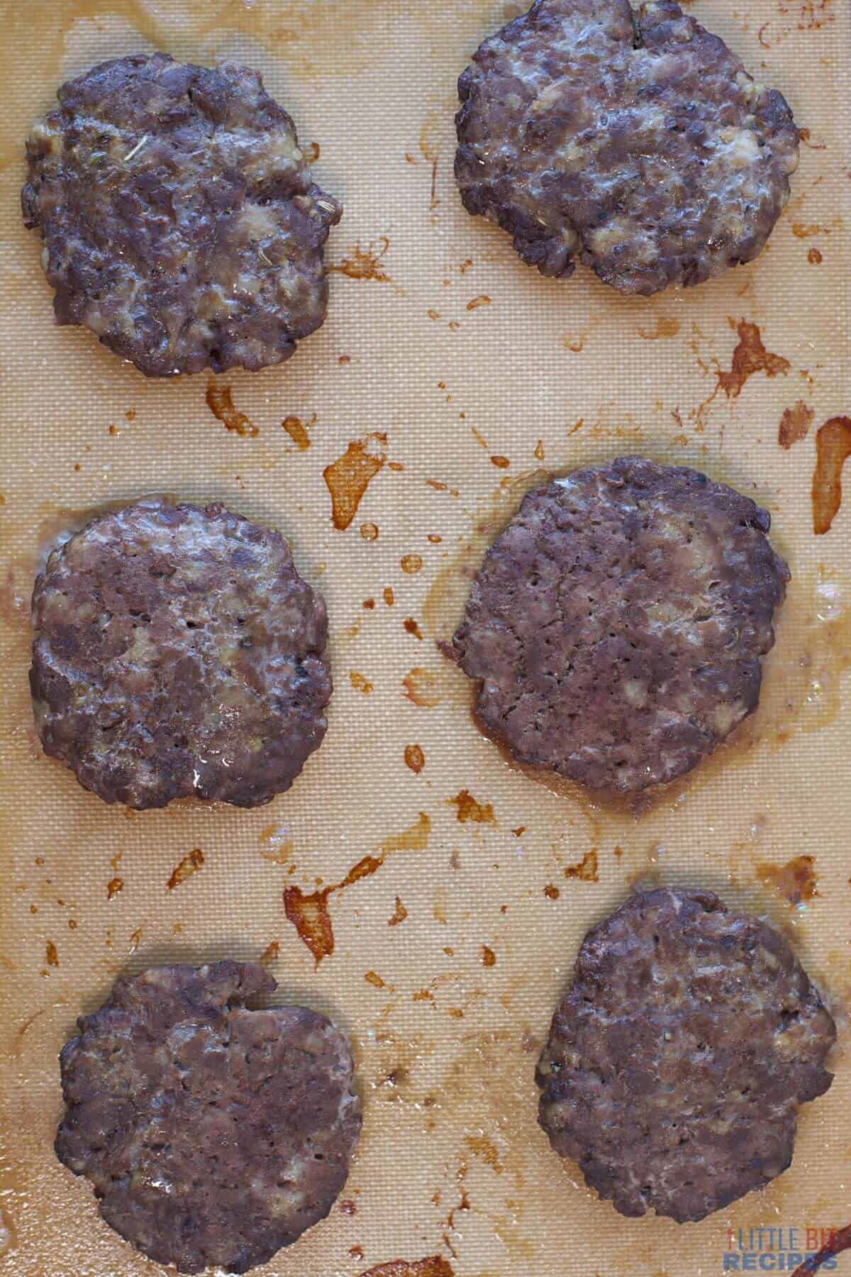 baked sausage patties on silicone mat.
