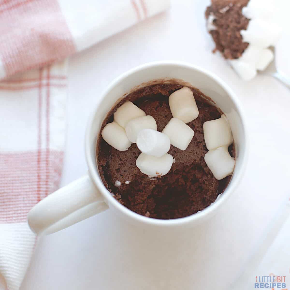 hot chocolate mug cake with spoonful taken out.