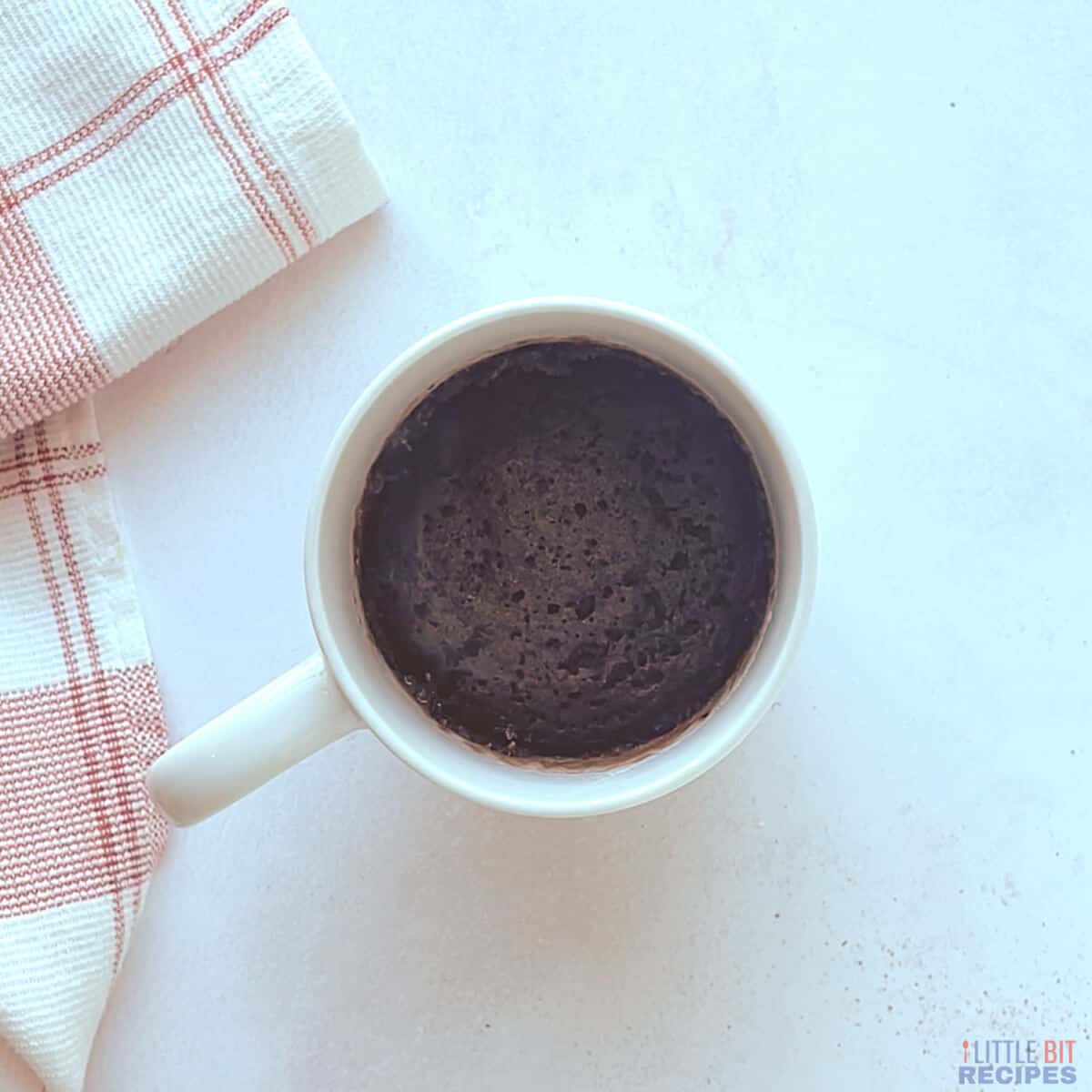 cooked hot cocoa mug cake in cup.