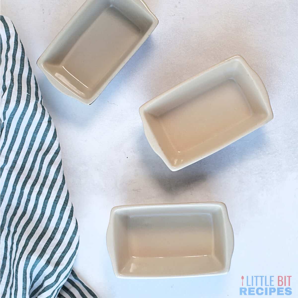 mini bread pans with striped towel.