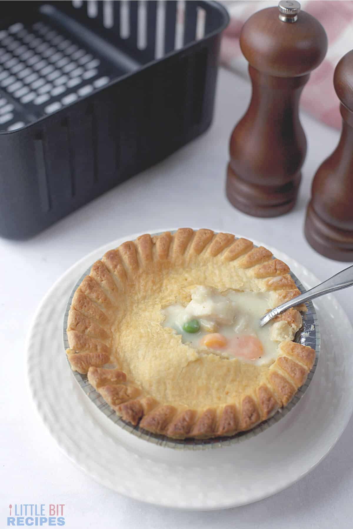 serving air fryer pot pie on plate.