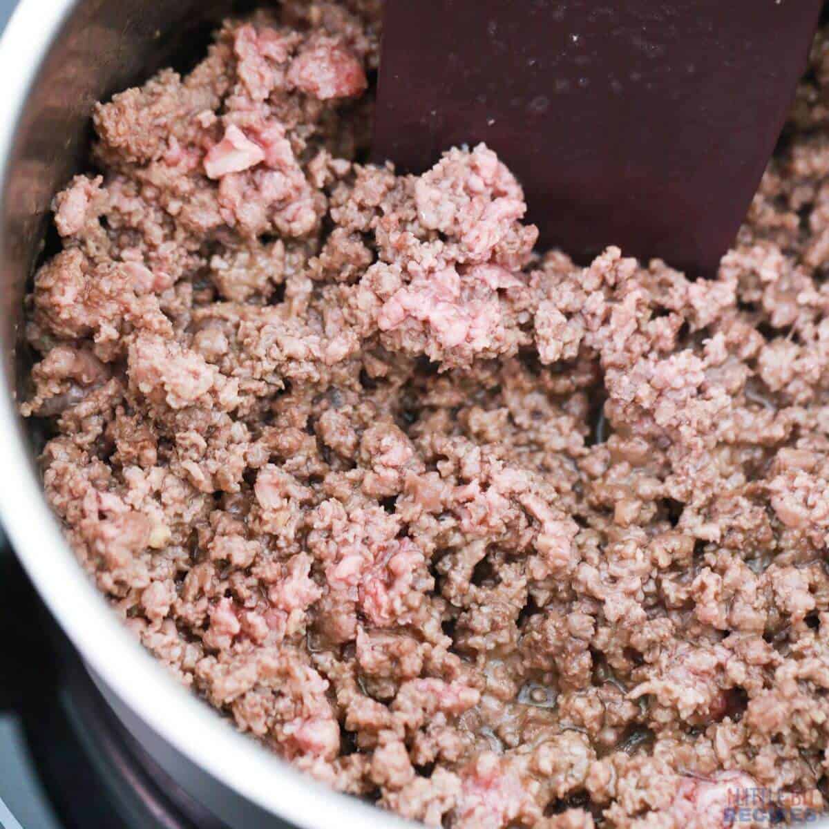 browning ground beef in pot.