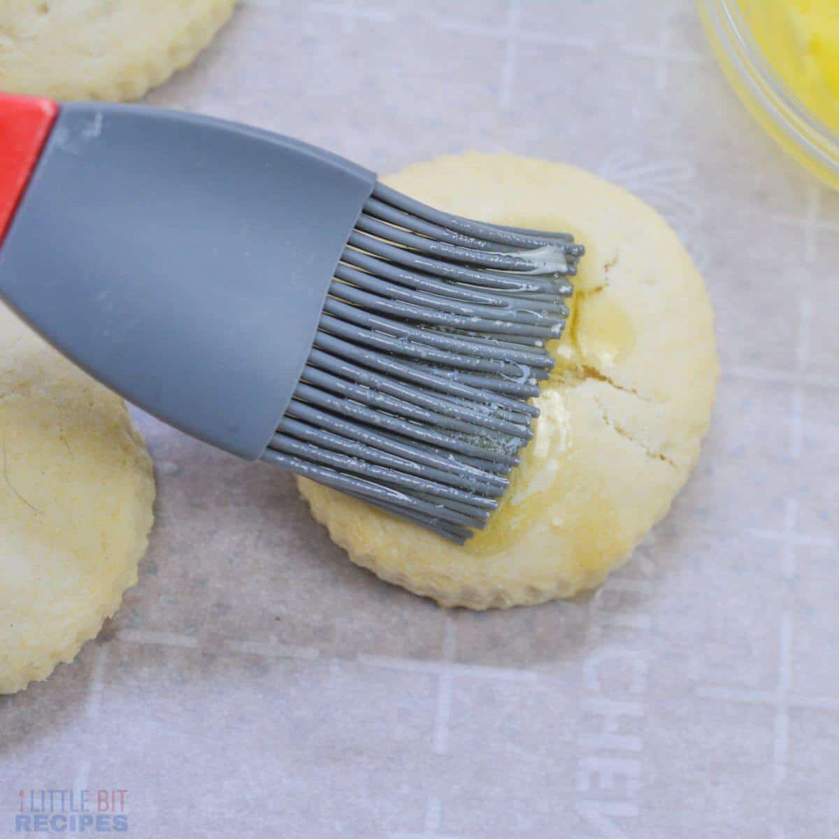brushing biscuit with melted butter.