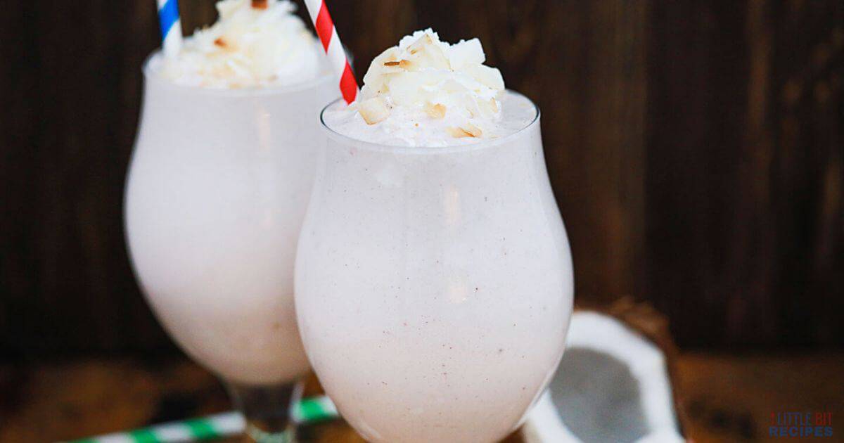 Coconut shakes with whipped cream and straw.