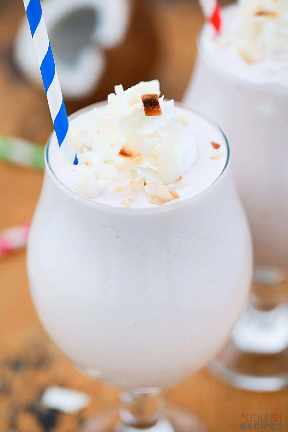 coconut shake with blue striped straw.