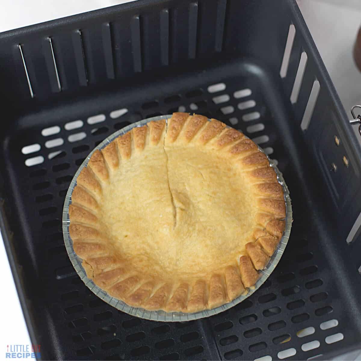 cooked pot pie in air fryer basket.
