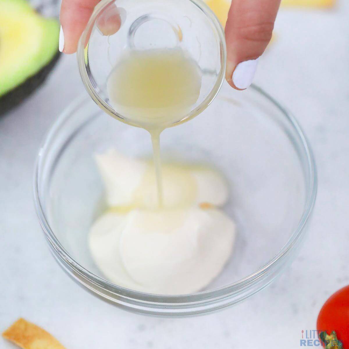 adding lime juice to mayonnaise.