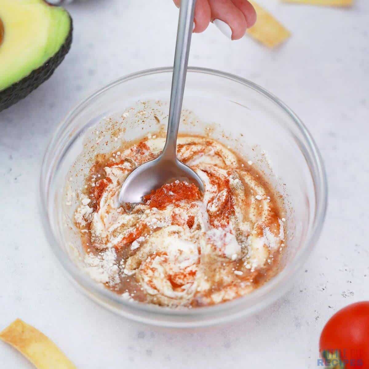 stirring salad dressing ingredients together.