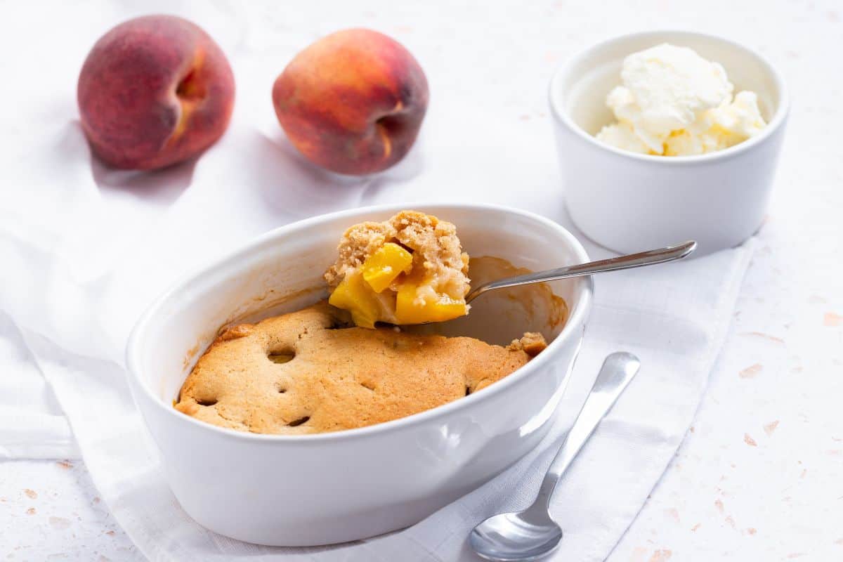 Peach cobbler for one with spoon in it.