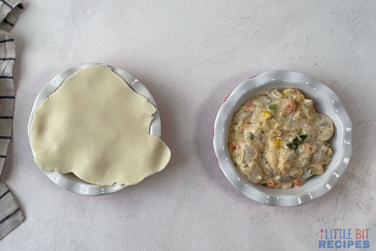 filling in pie dishes with one topped with crust.