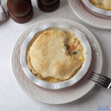 seafood pot pie in ceramic dish with bite out.