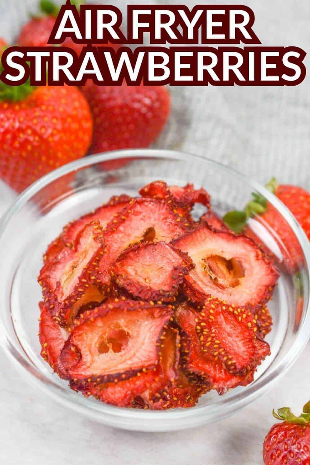 Air fryer strawberries in glass bowl with recipe title text overlay.