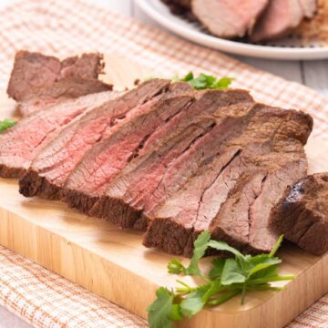 sliced carne asada on cutting board.