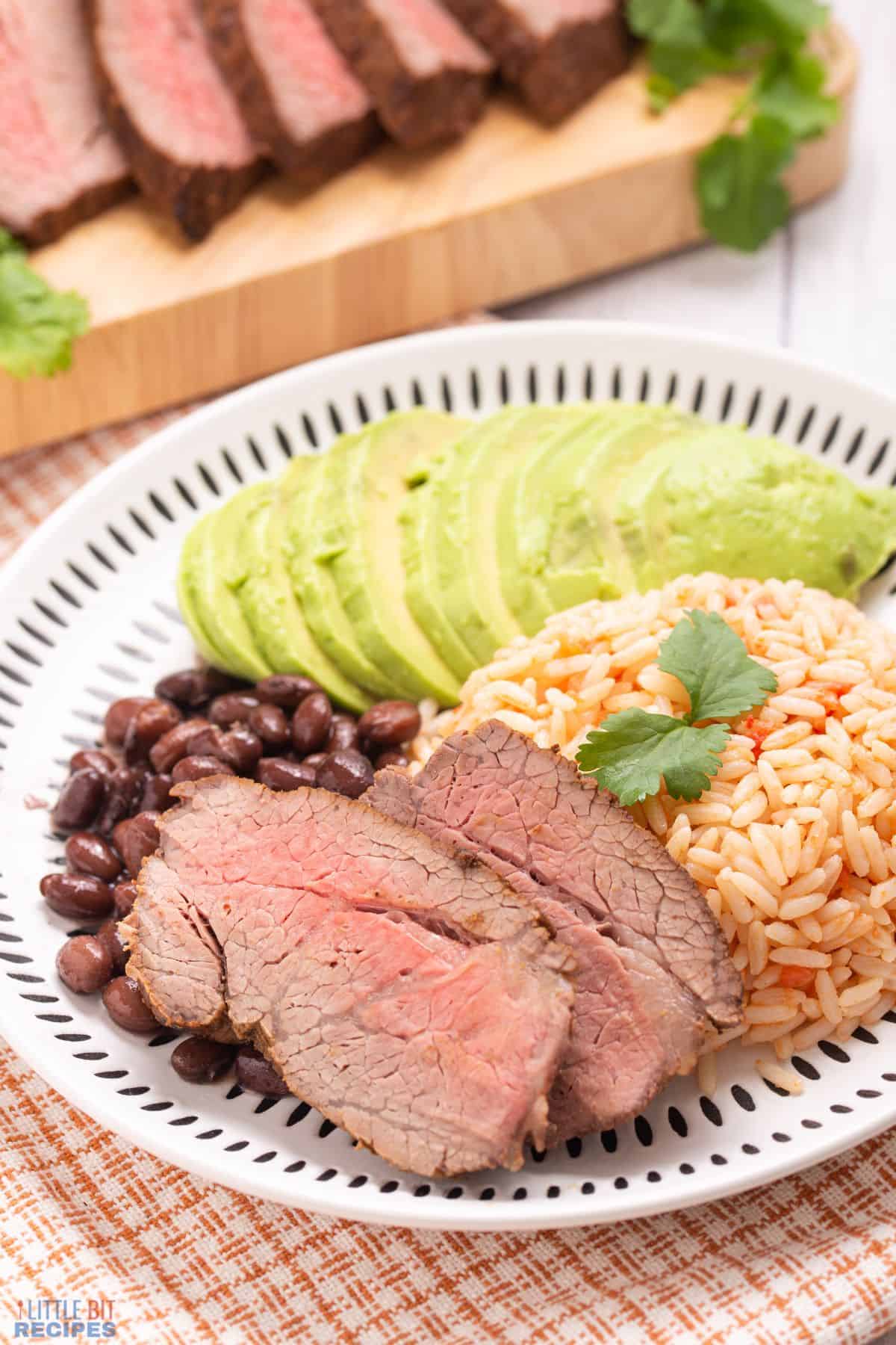 slices of beef with side dishes.