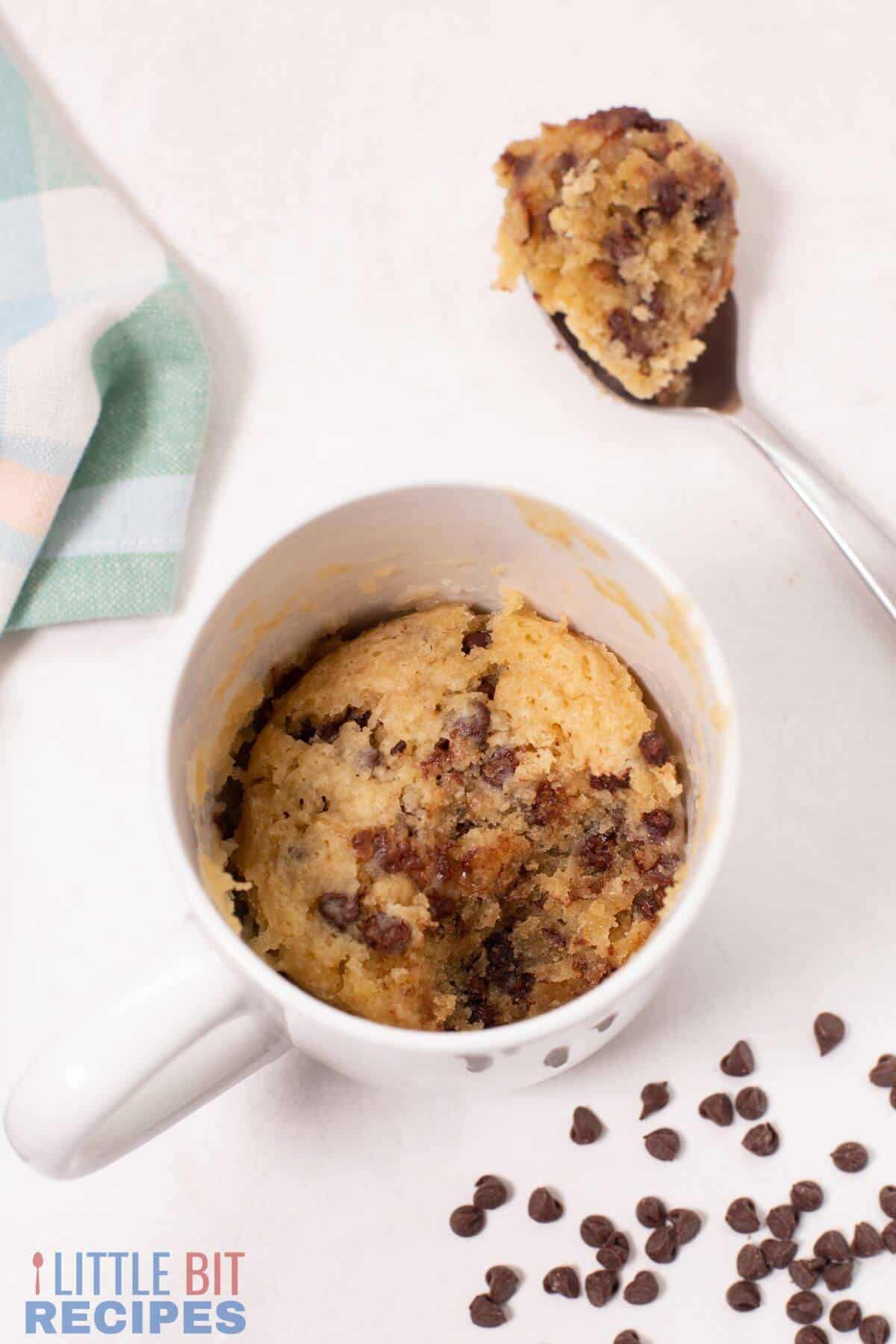 spoon bite of cake on side of mug cake.