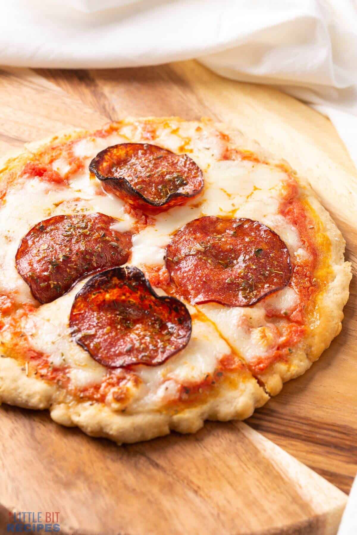 personal pizza baked and sliced.