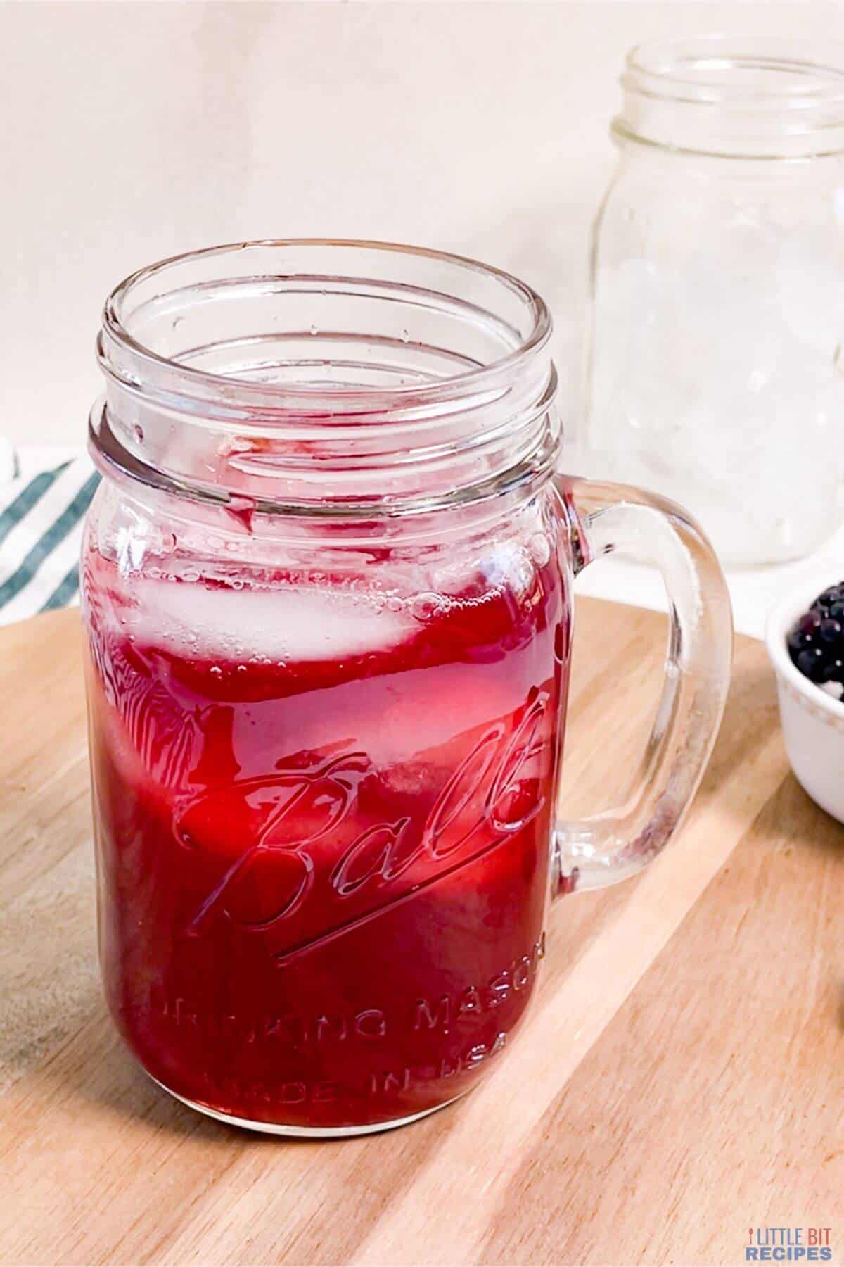 strained blackberry tea in drinking glass.