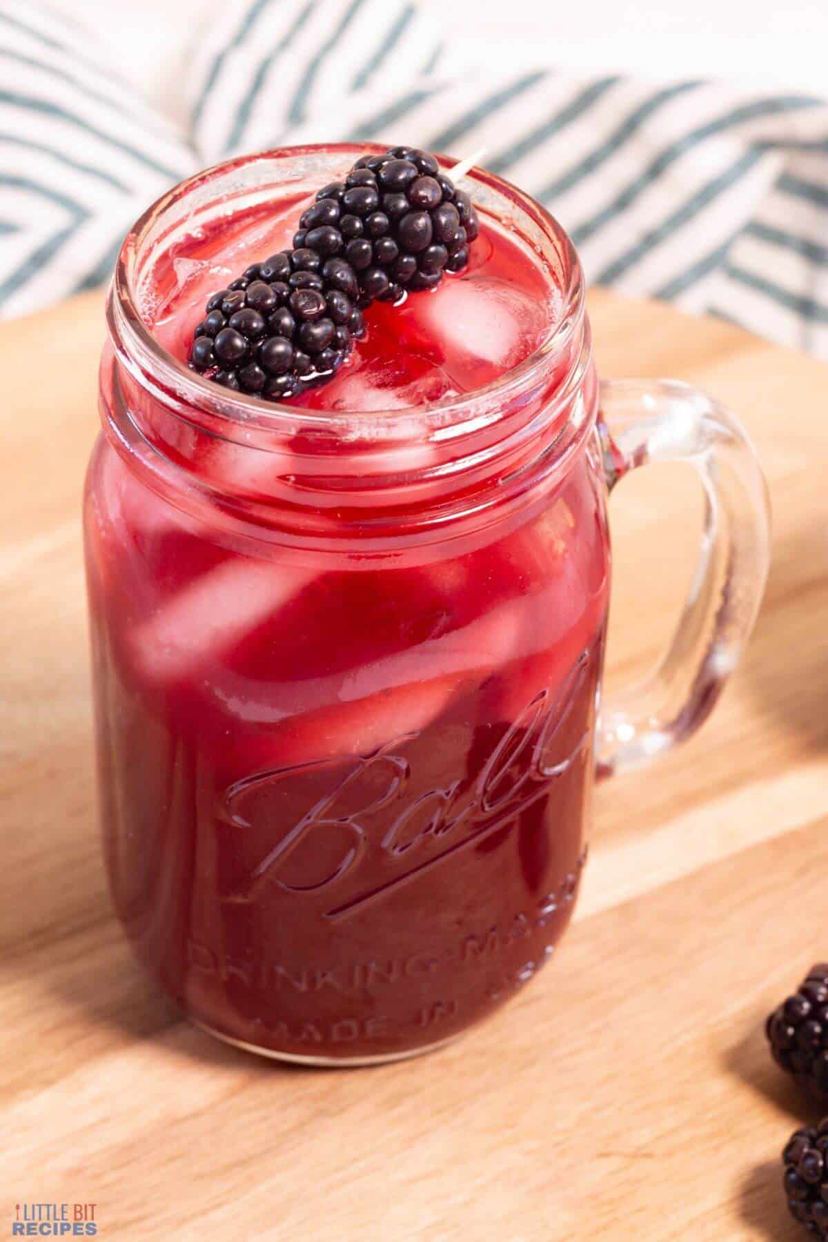 mason jar glass of blackberry sweet tea.