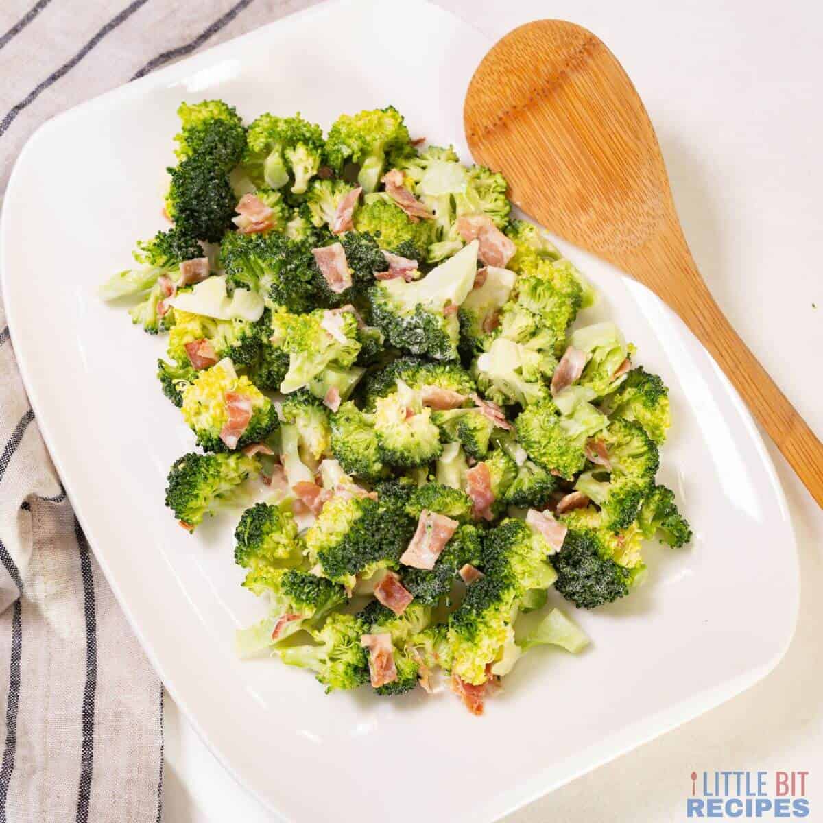 broccoli salad with bacon and wooden spoon.