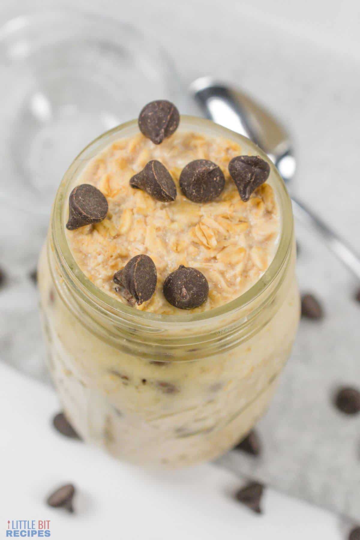 overnight oats in mason jar topped with chocolate chips.