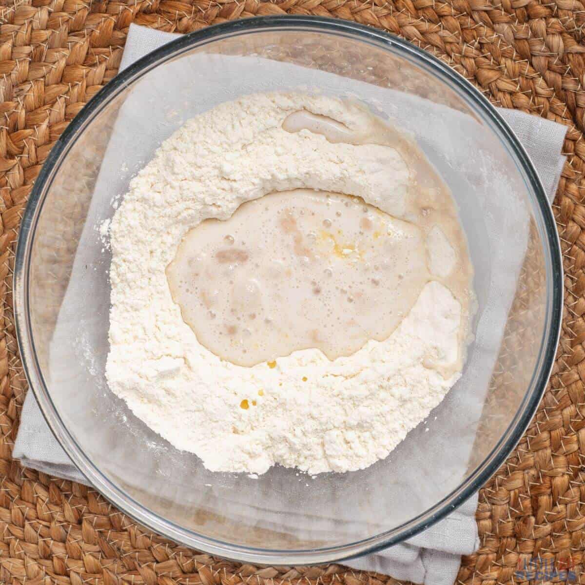flour and yeast mixture with butter in bowl.
