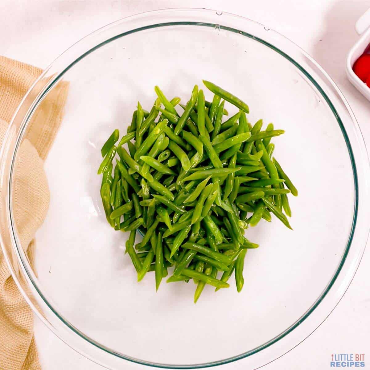 cooled green beans in glass mixing bowl.