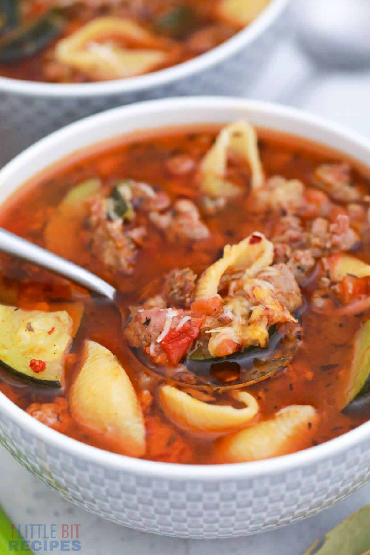 minestrone soup in bowl with spoonful.