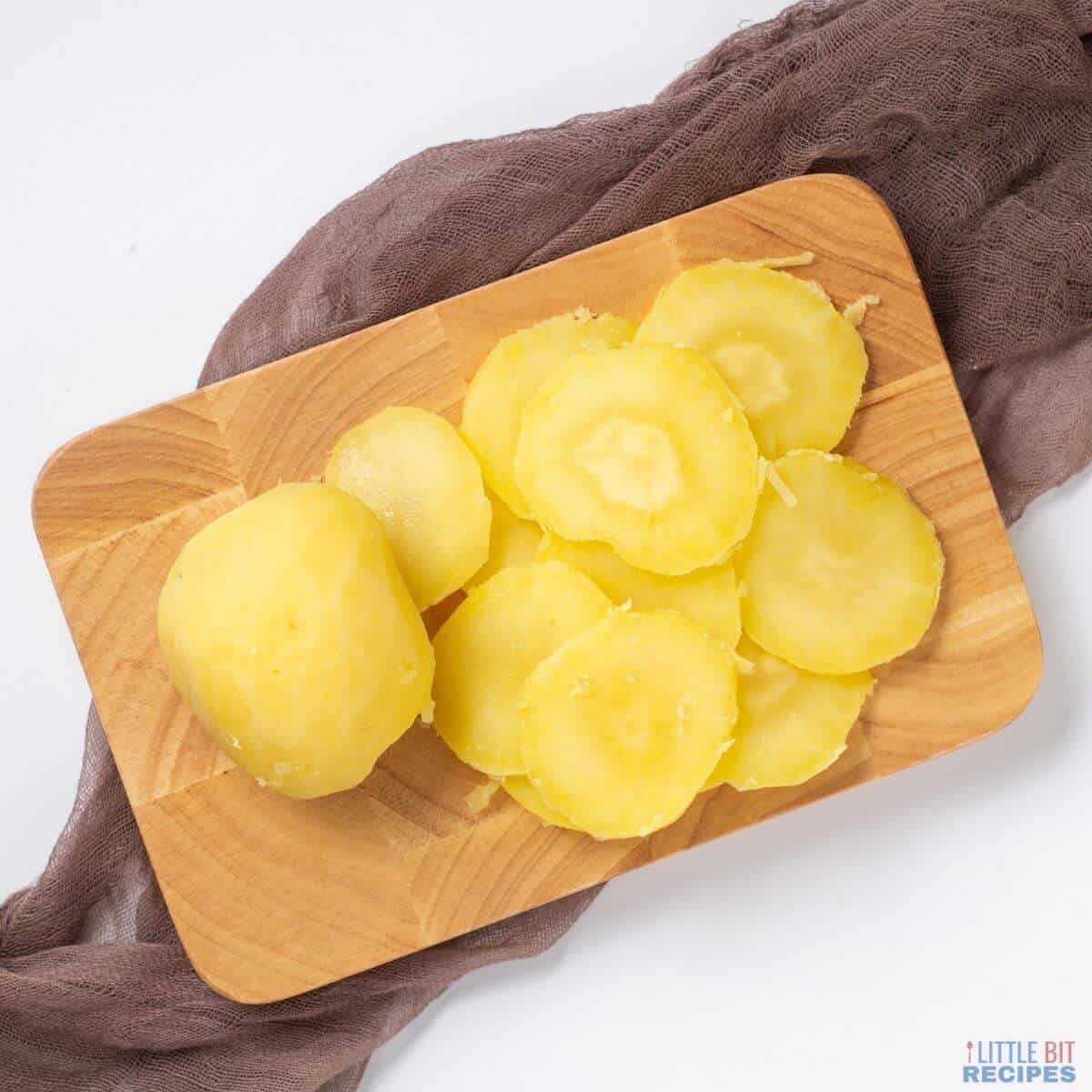 sliced potatoes on cutting board.