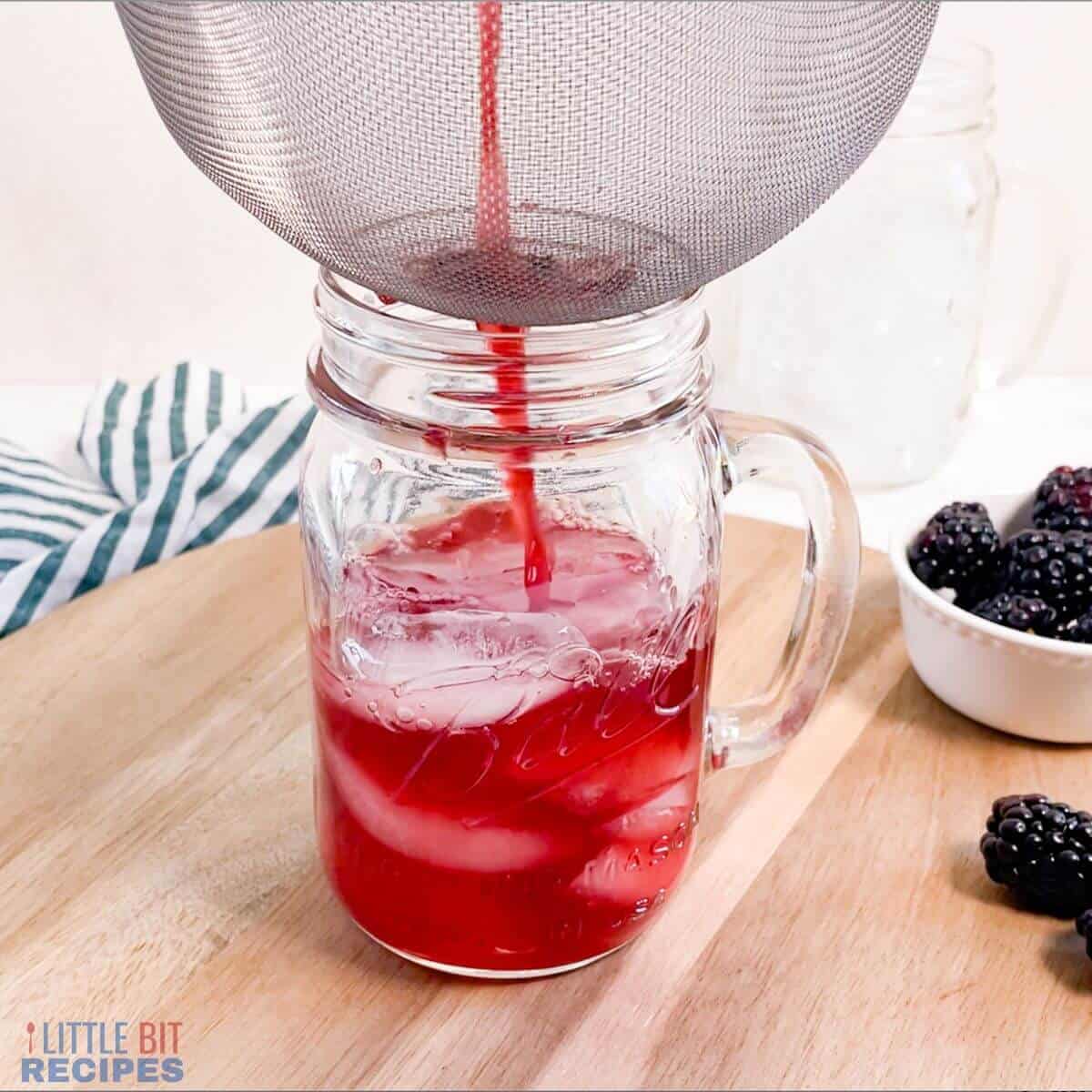 straining blackberry tea.