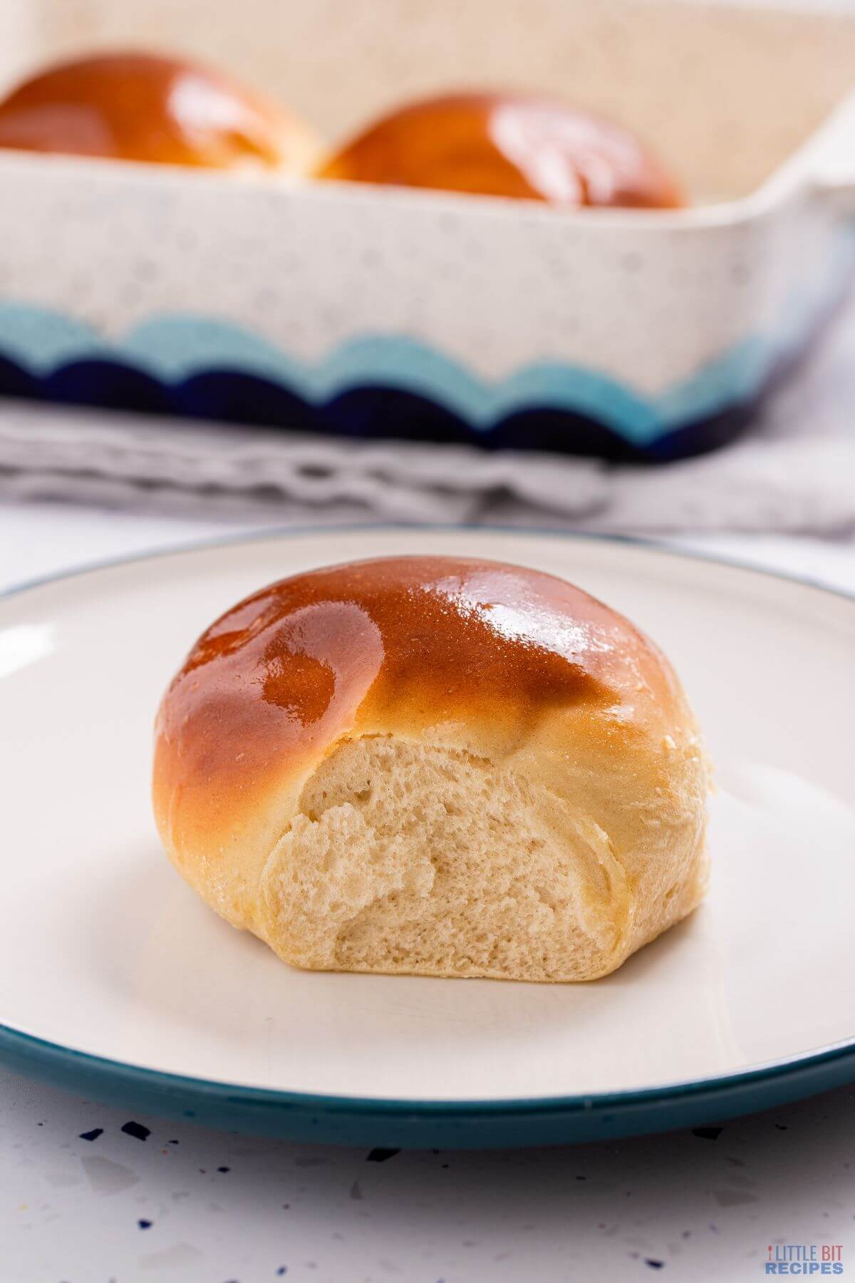 yeast roll on white plate.