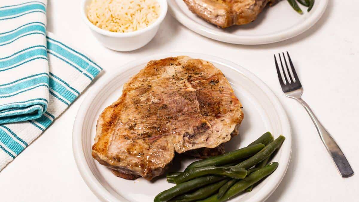 baked pork steaks with green beans and rice.