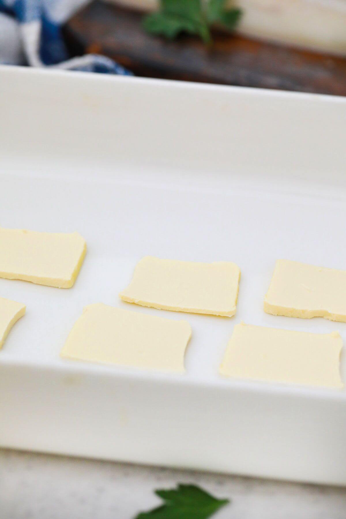 pats of butter in baking dish.