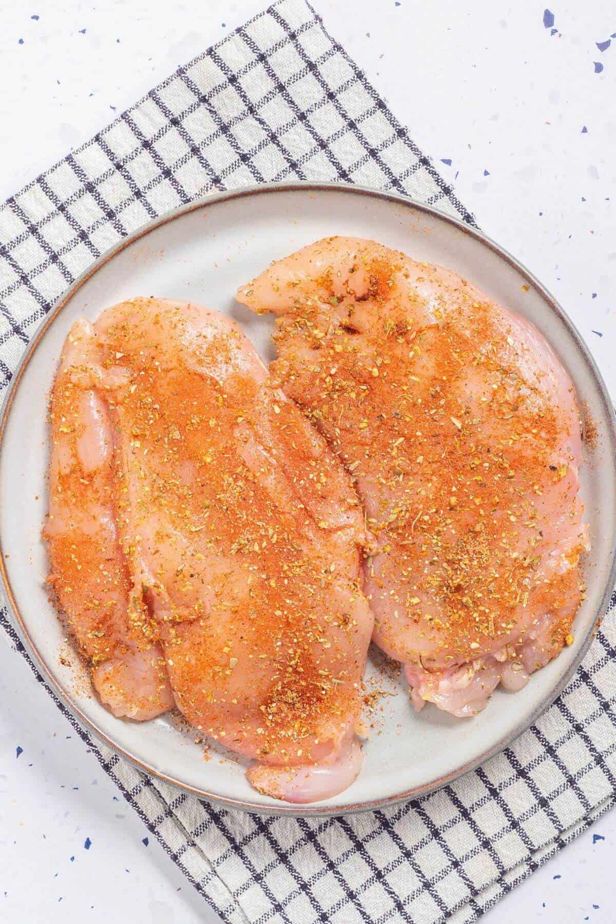 seasoned pounded chicken on plate.