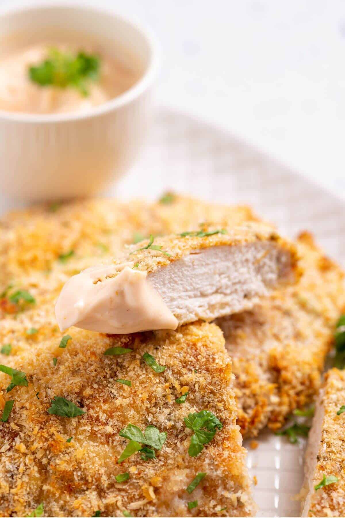 slice of panko chicken with dip.