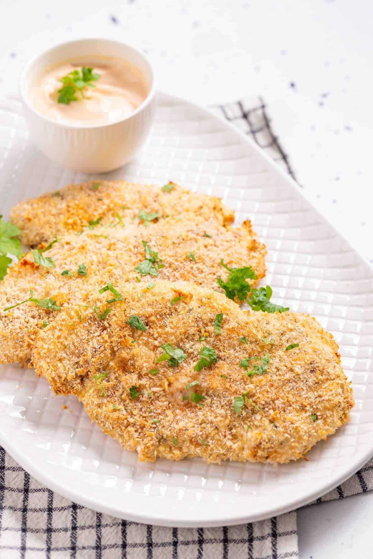 serving panko chicken with dipping sauce.