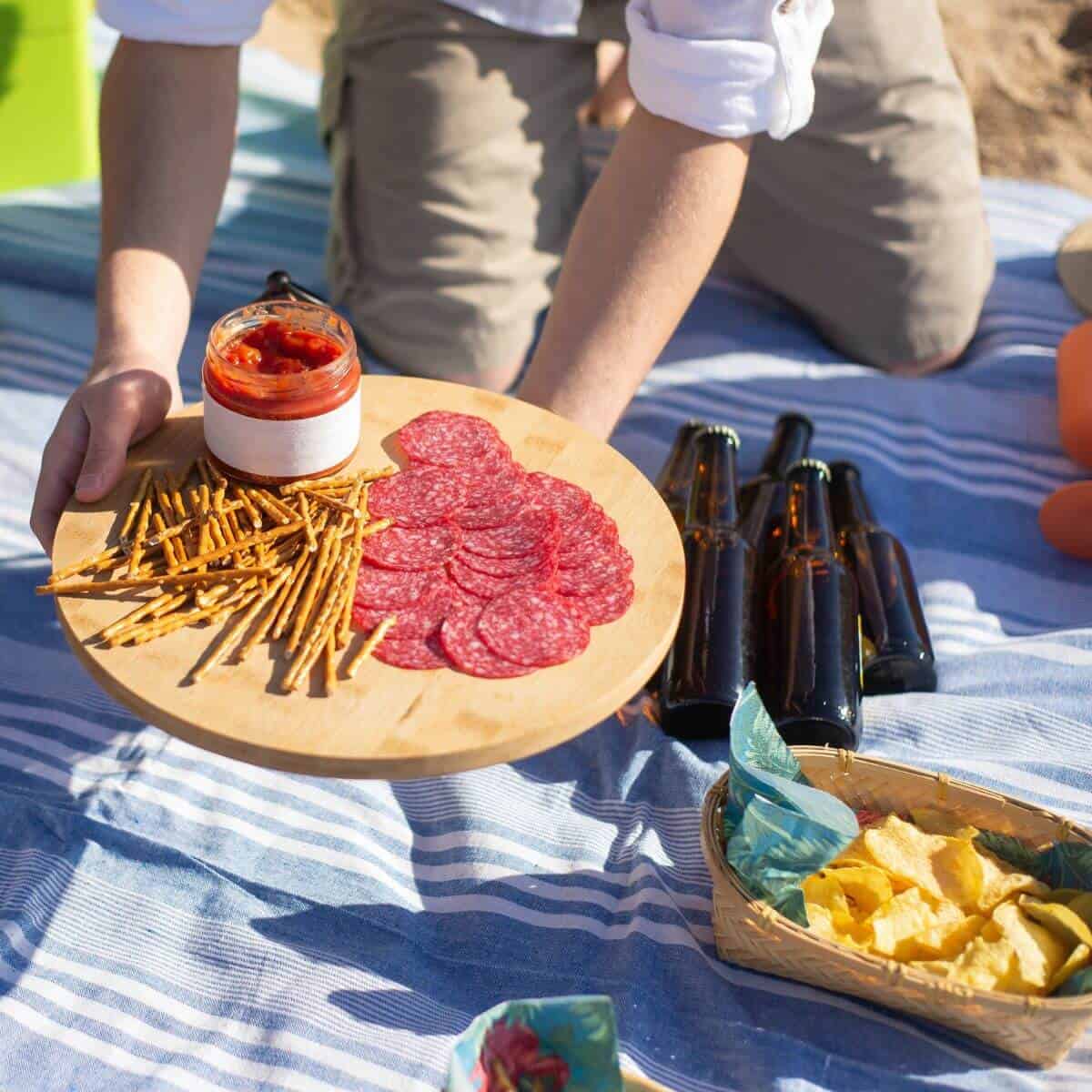 tray of party foods with chips and beer.