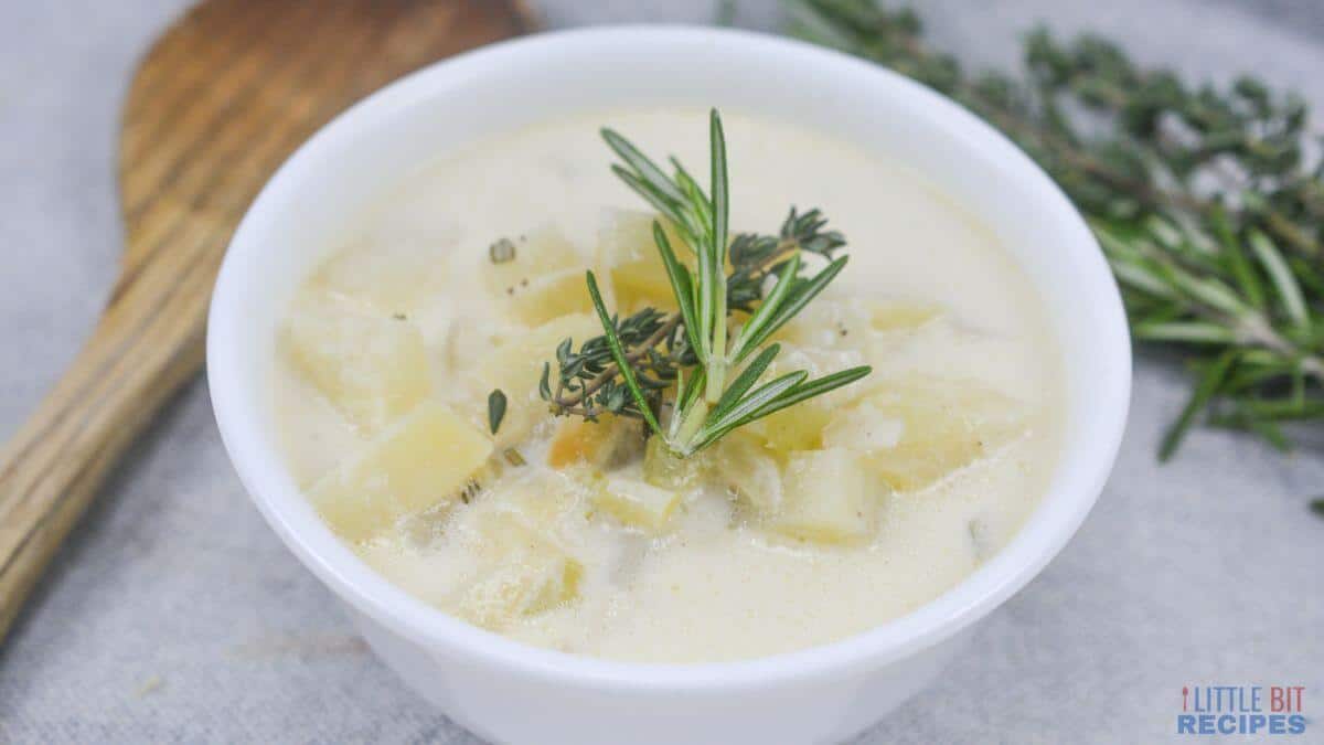 Potato soup in a white serving bowl.