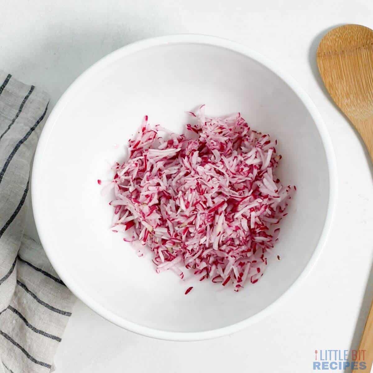 grated radishes in mixing bowl.