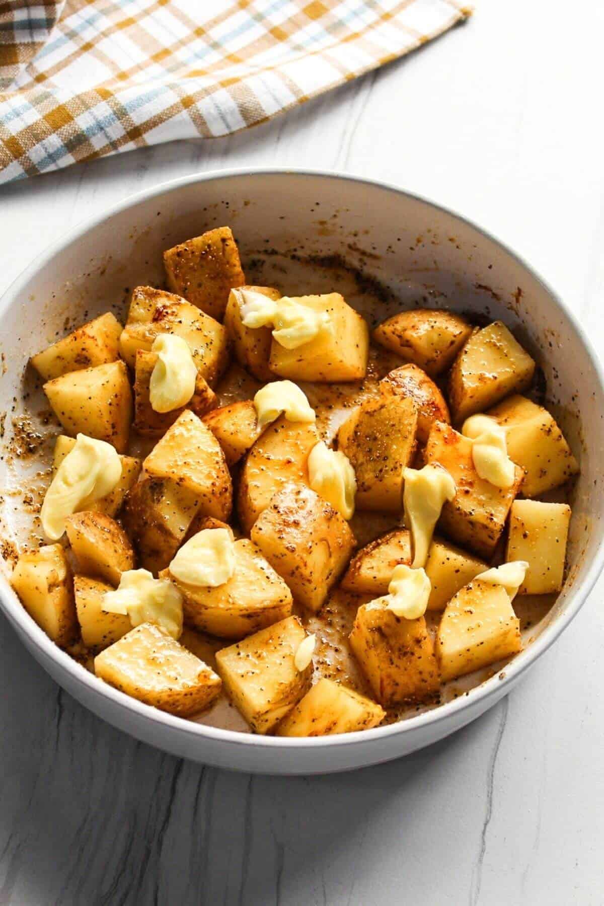 Butter added to seasoned potatoes.