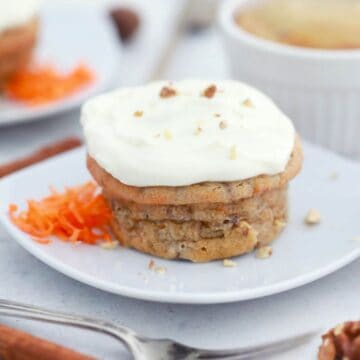Carrot mug cake shown on plate with frosting.