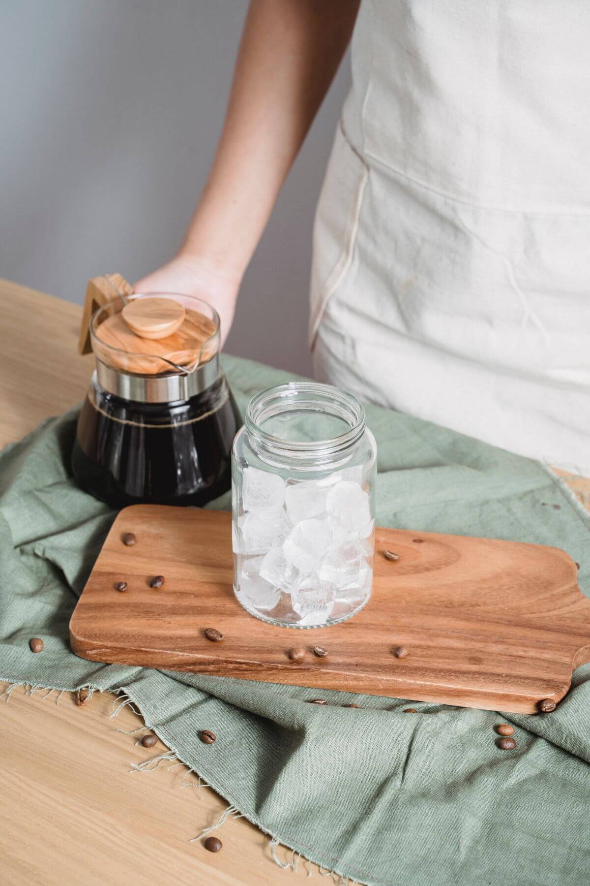 Cold brew coffee in carafe with jar of ice.