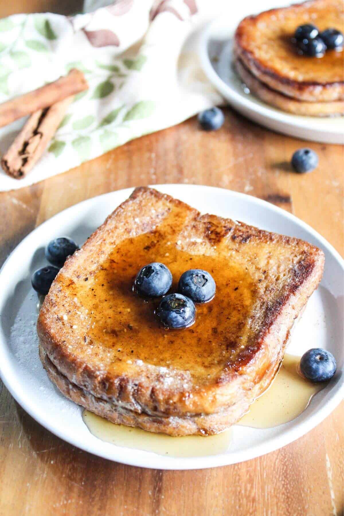 French toast served with syrup and blueberries.