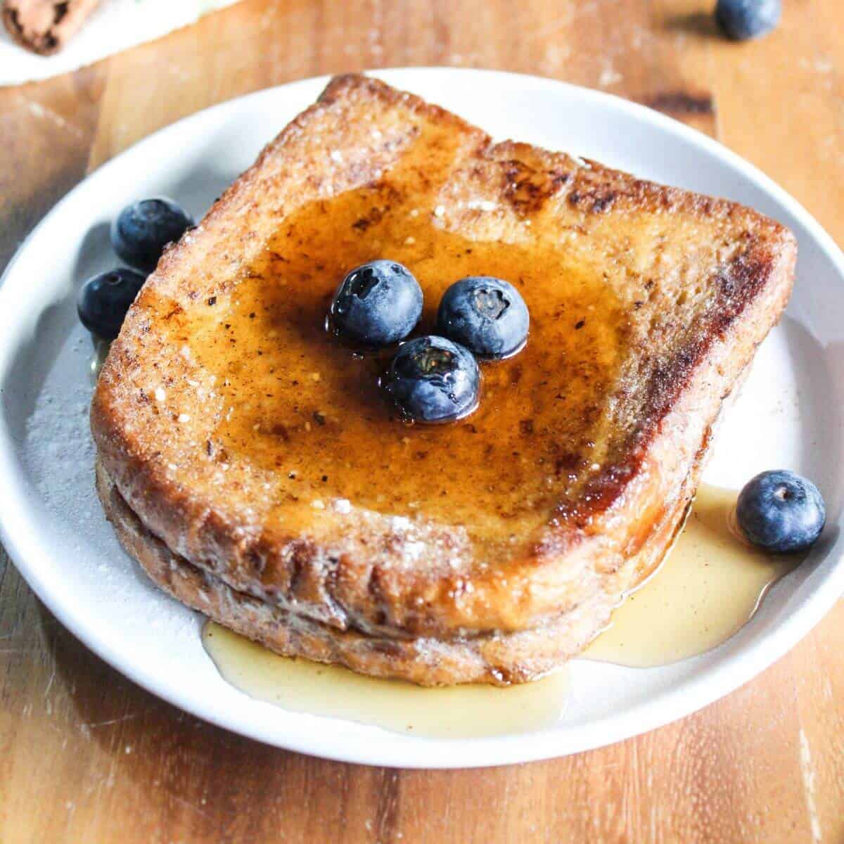 Slice of brioche french toast for one with syrup.
