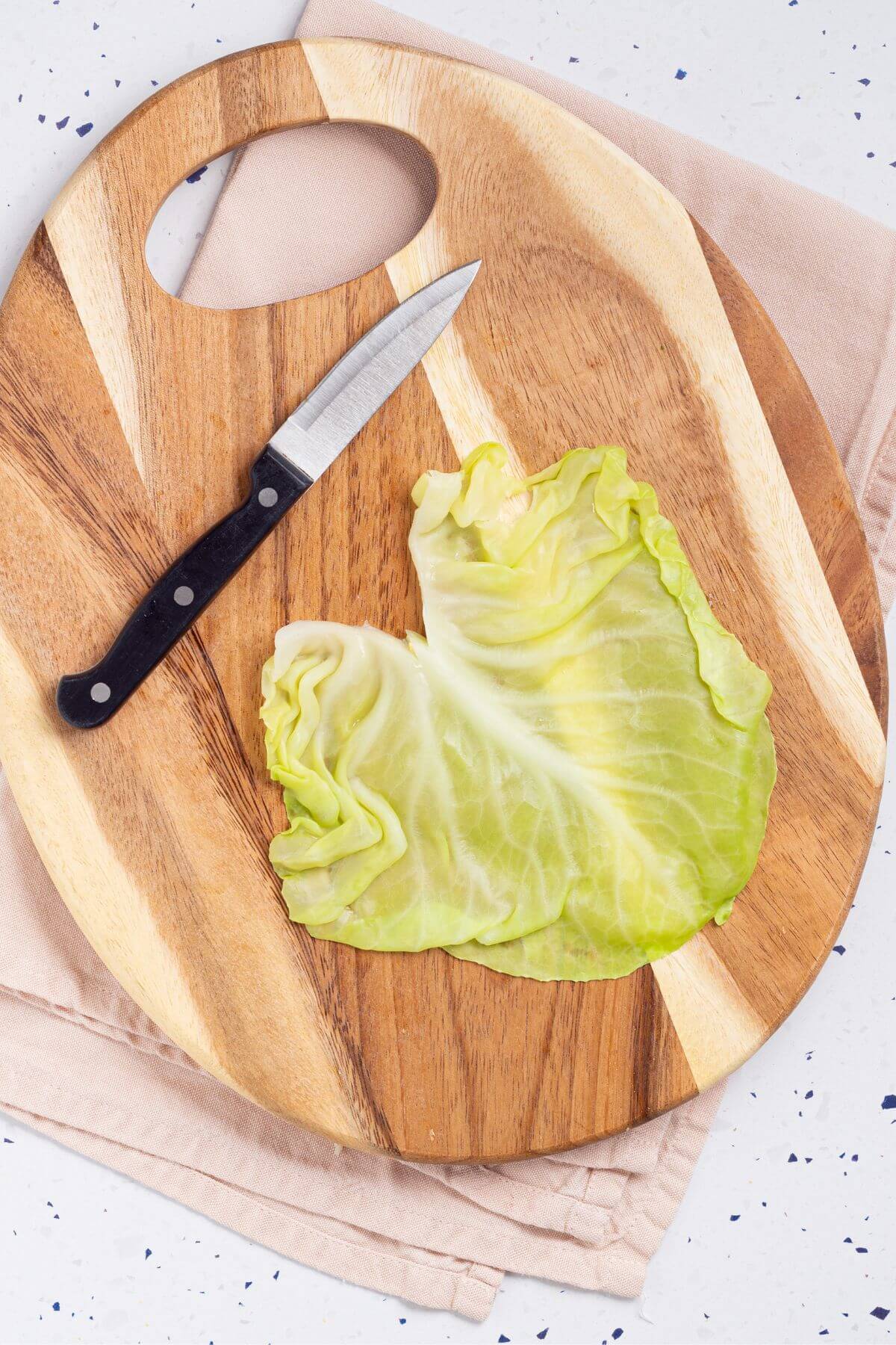 Prepared cabbage leaf on cutting board.