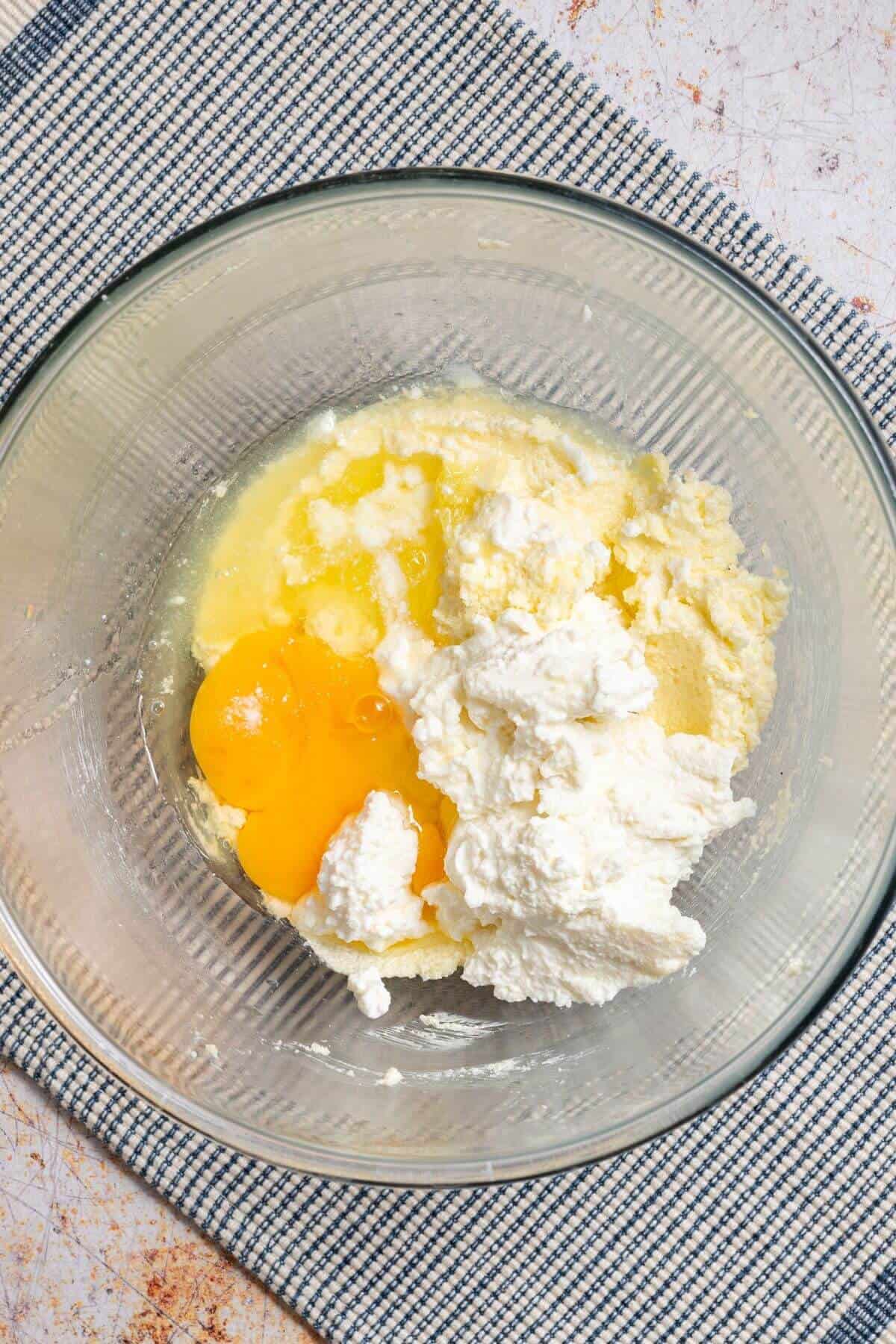 Ricotta cheese, egg, and lemon juice added to bowl.