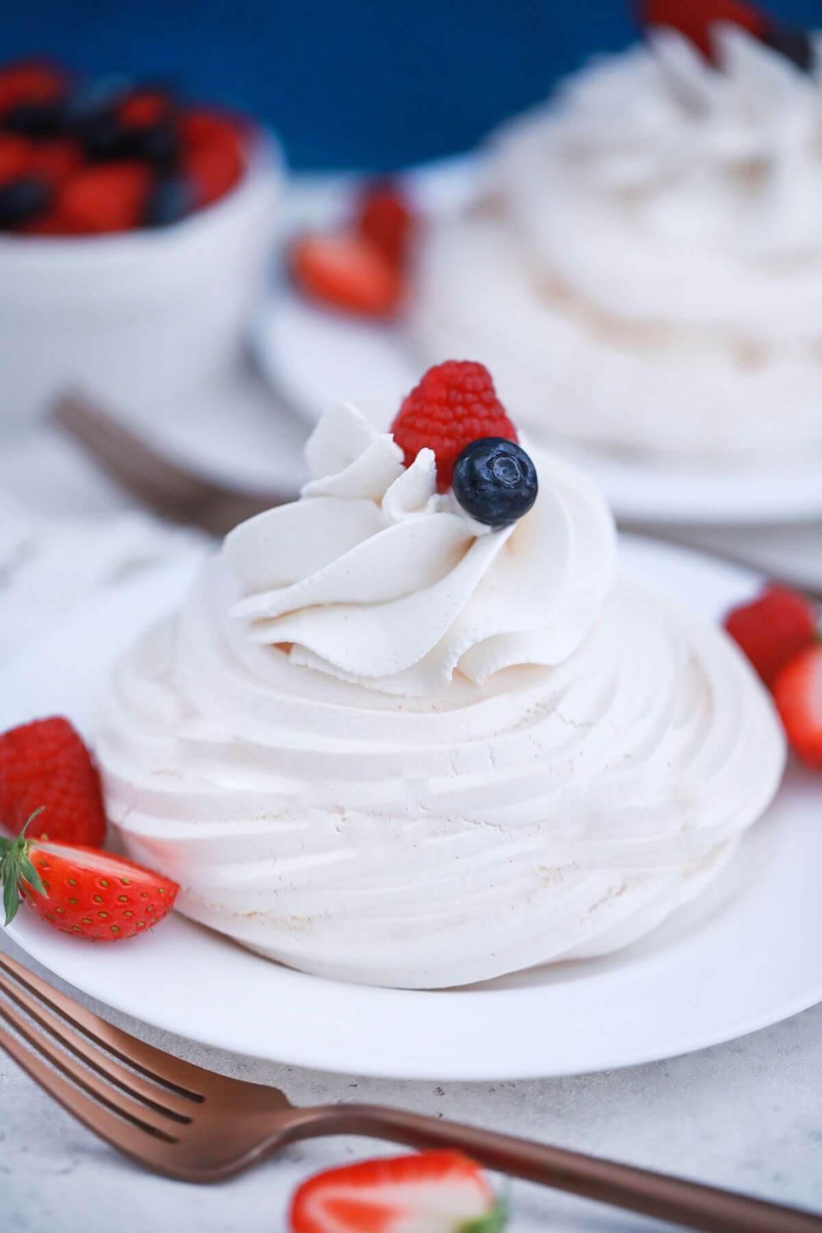 Mini pavlova with whipped cream and berries.