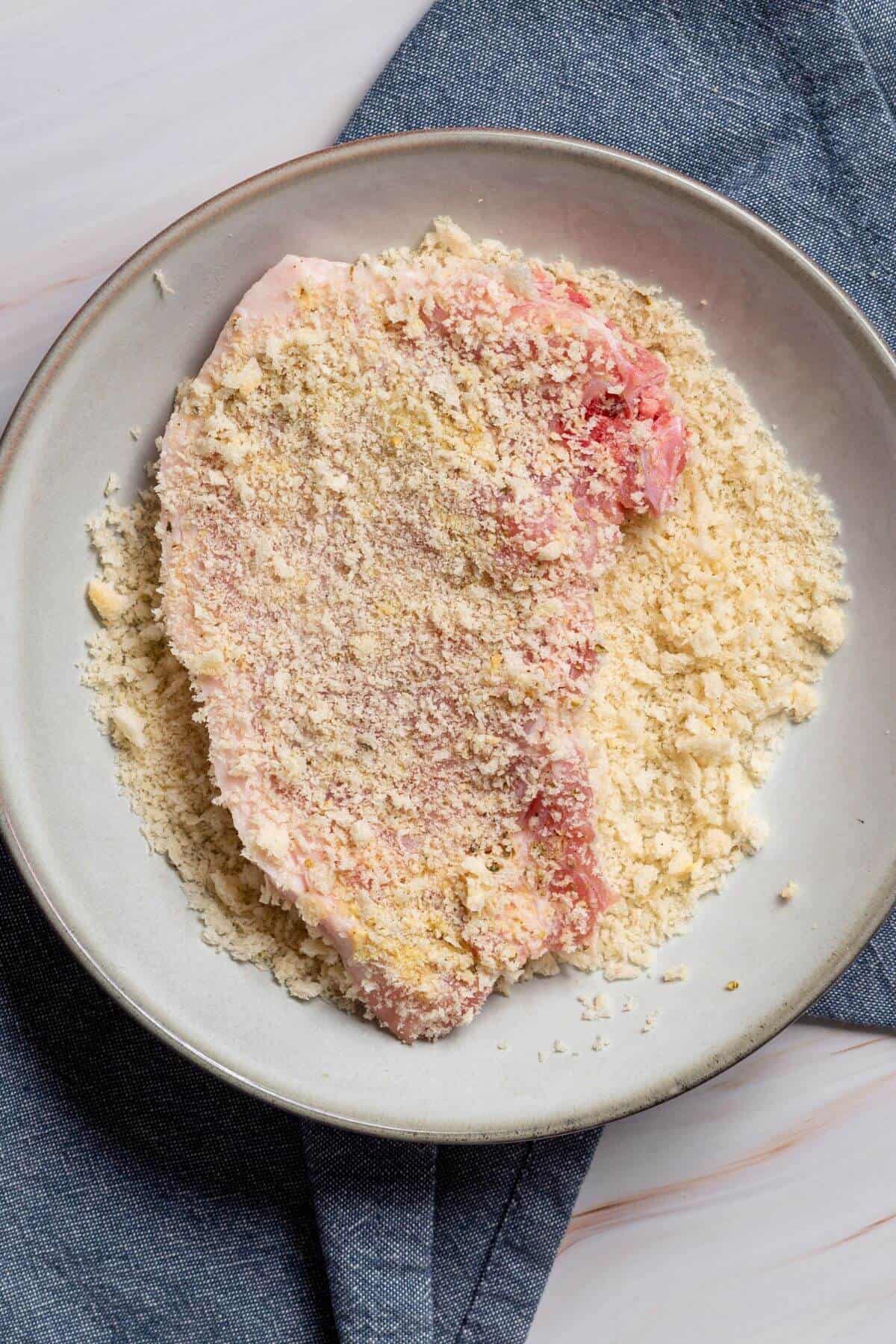 Meat dipped and covered in bread crumbs.