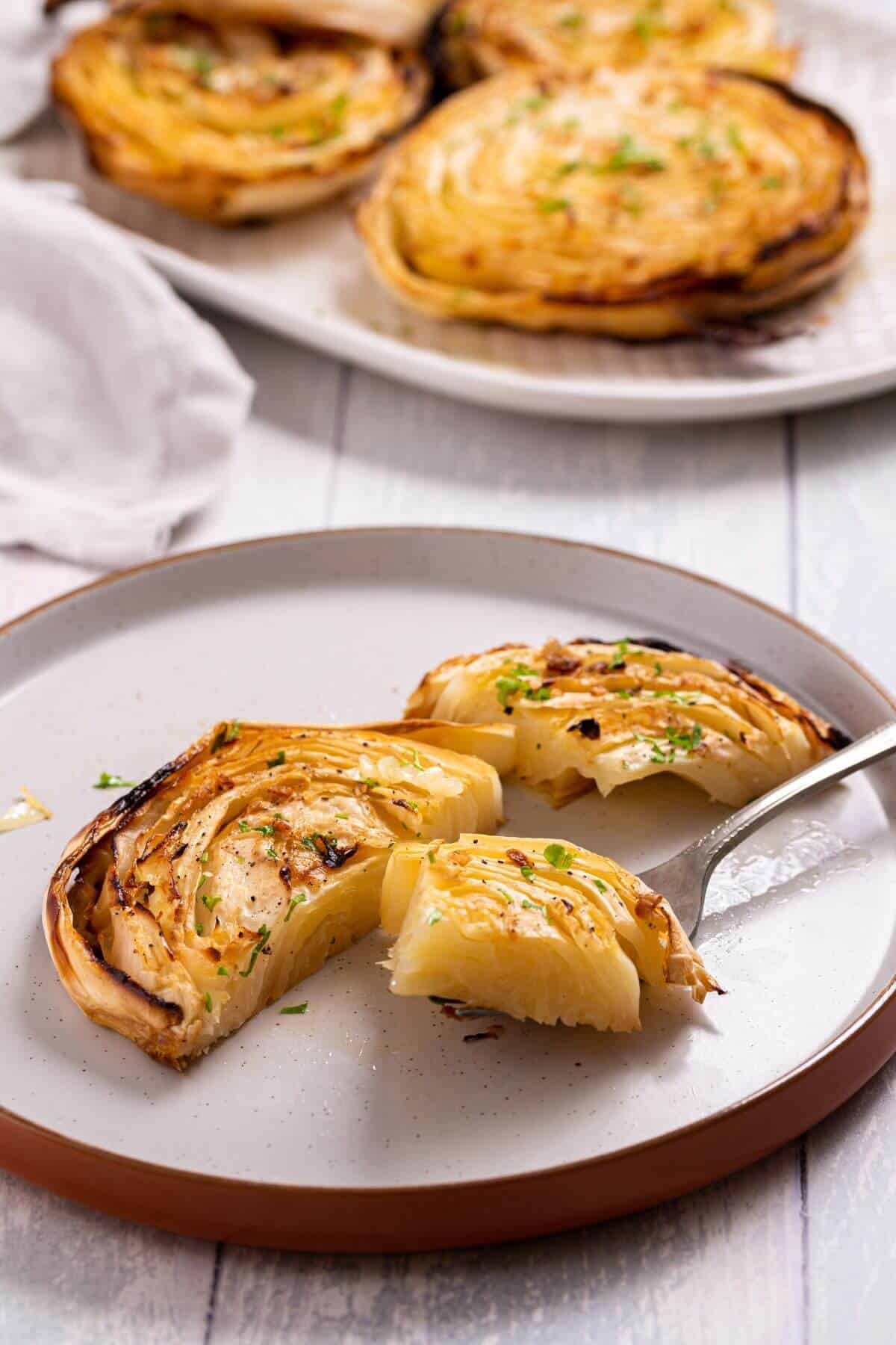 Bite of cabbage steak on fork.