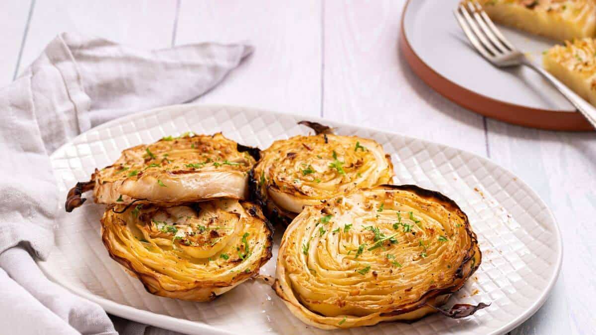 Roasted cabbage steaks on serving platter.